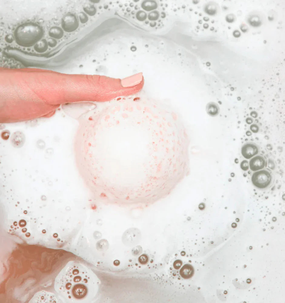 Caramelle da bagno colorate su sfondo vasca, con burro di karité e olio di cocco